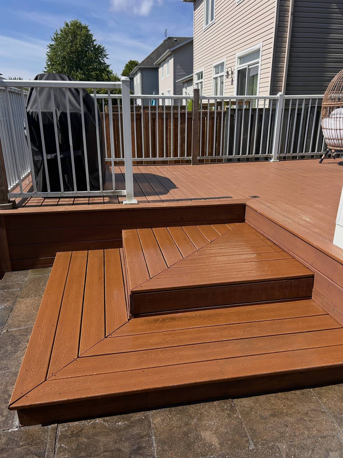 Cedar-tone composite deck with steps in Kingston, Ontario