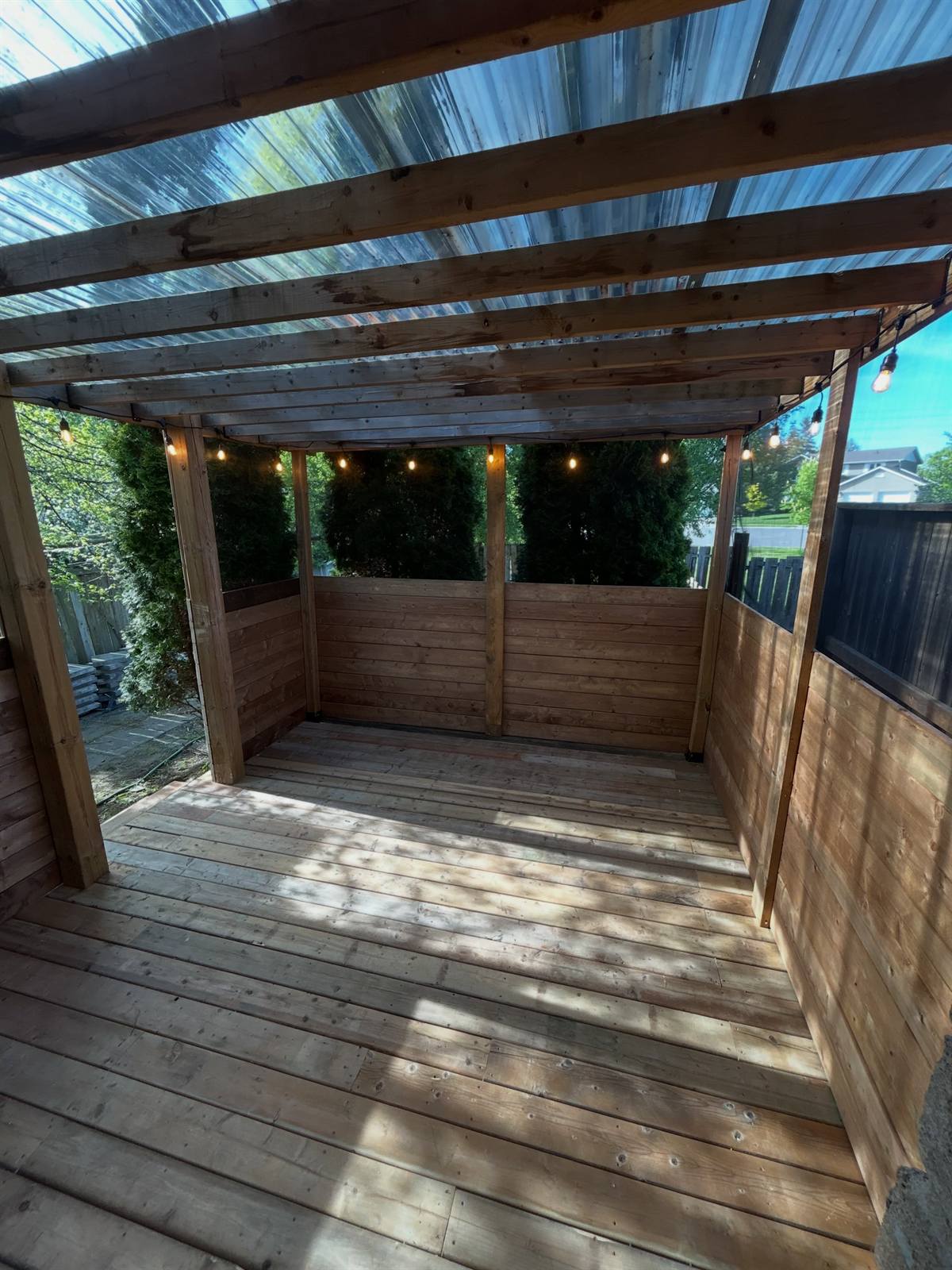 Covered cedar pergola with polycarbonate roof in Kingston, Ontario