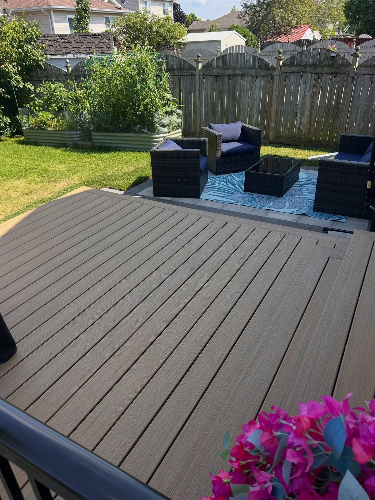 Composite deck beside a flagstone and river-rock path in Kingston, Ontario