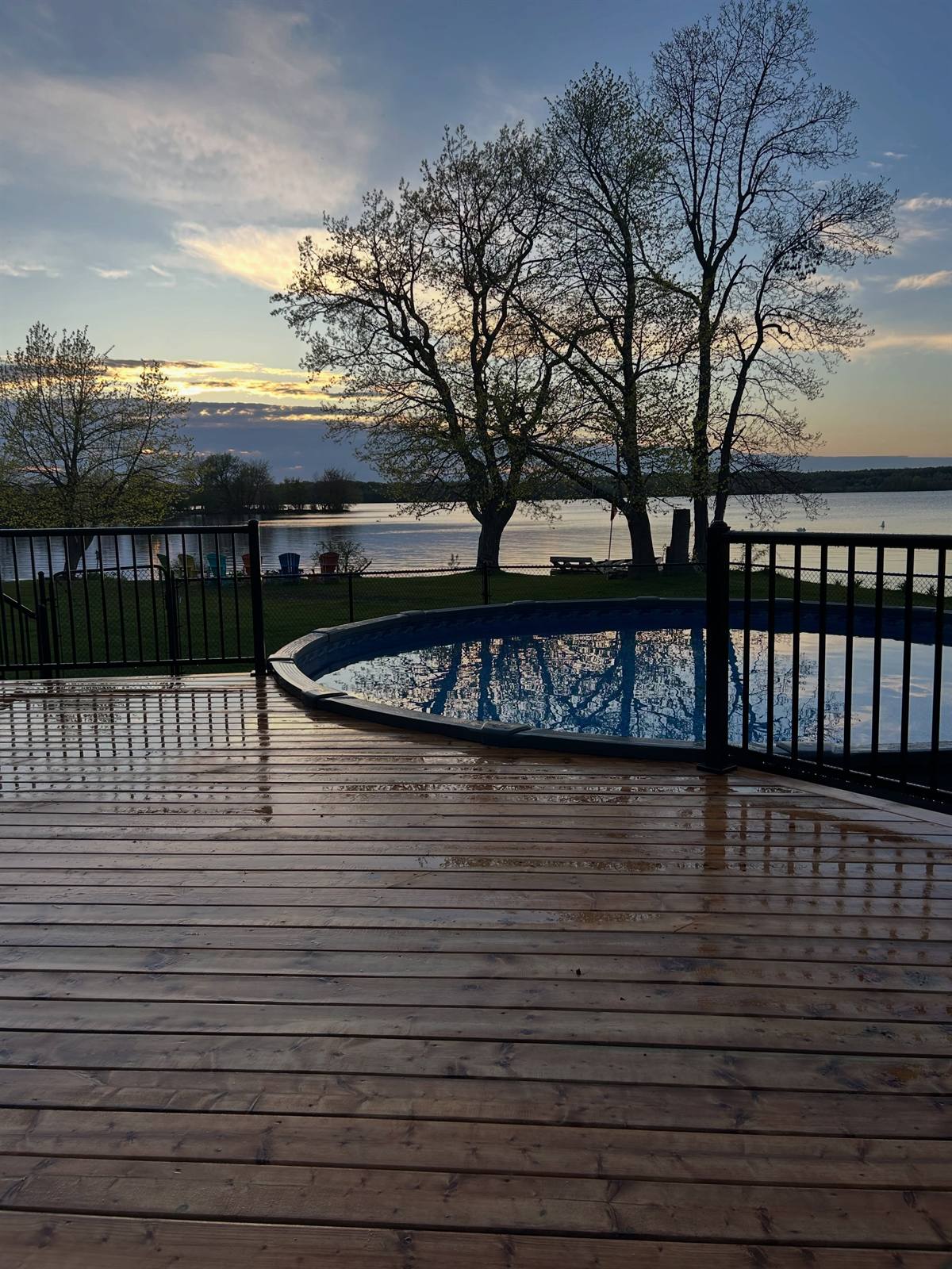 Wood pool deck at sunset overlooking the lake near Kingston, Ontario