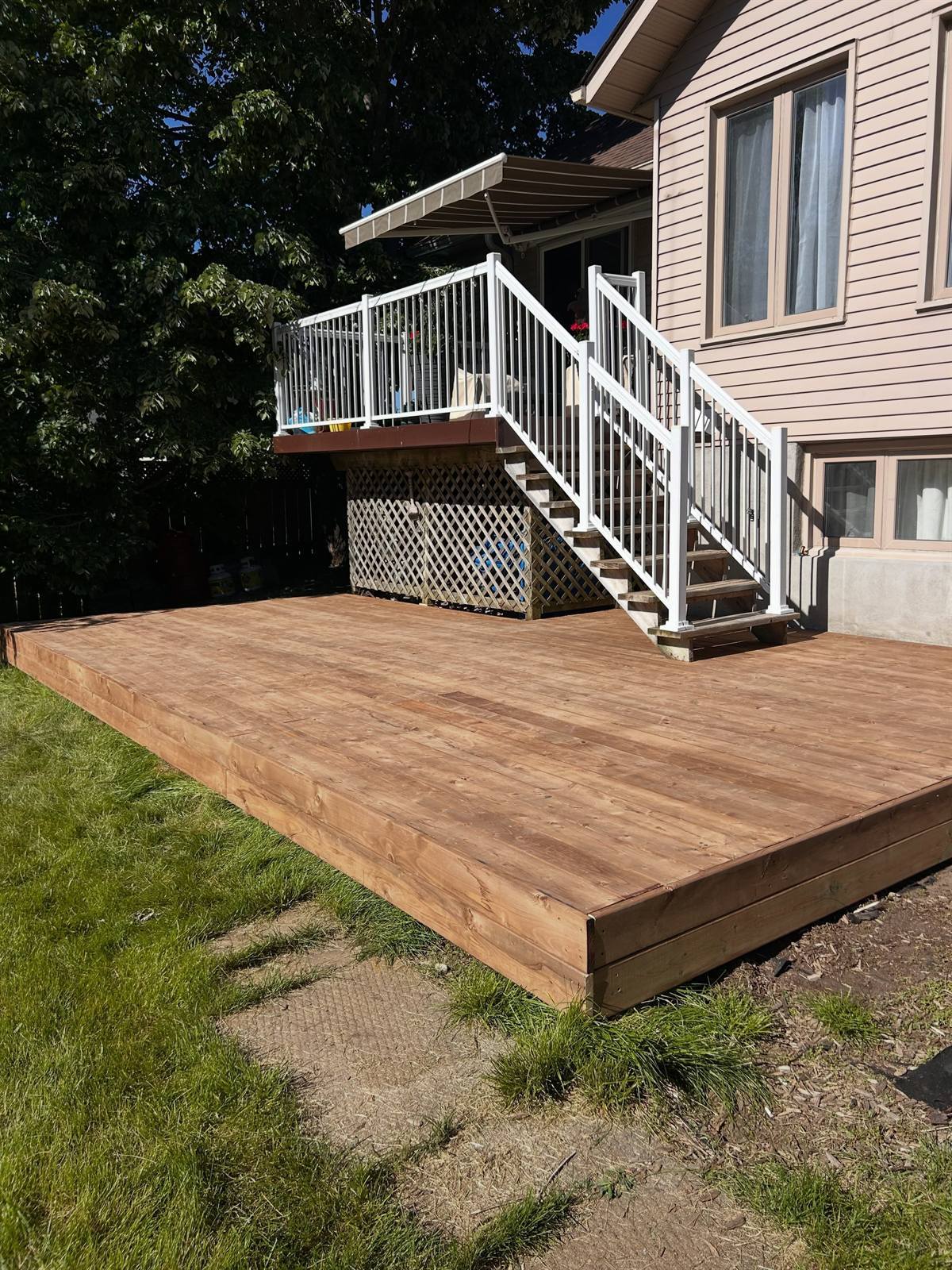 Wood deck with white railing built by Gonzo Construction in the Kingston area