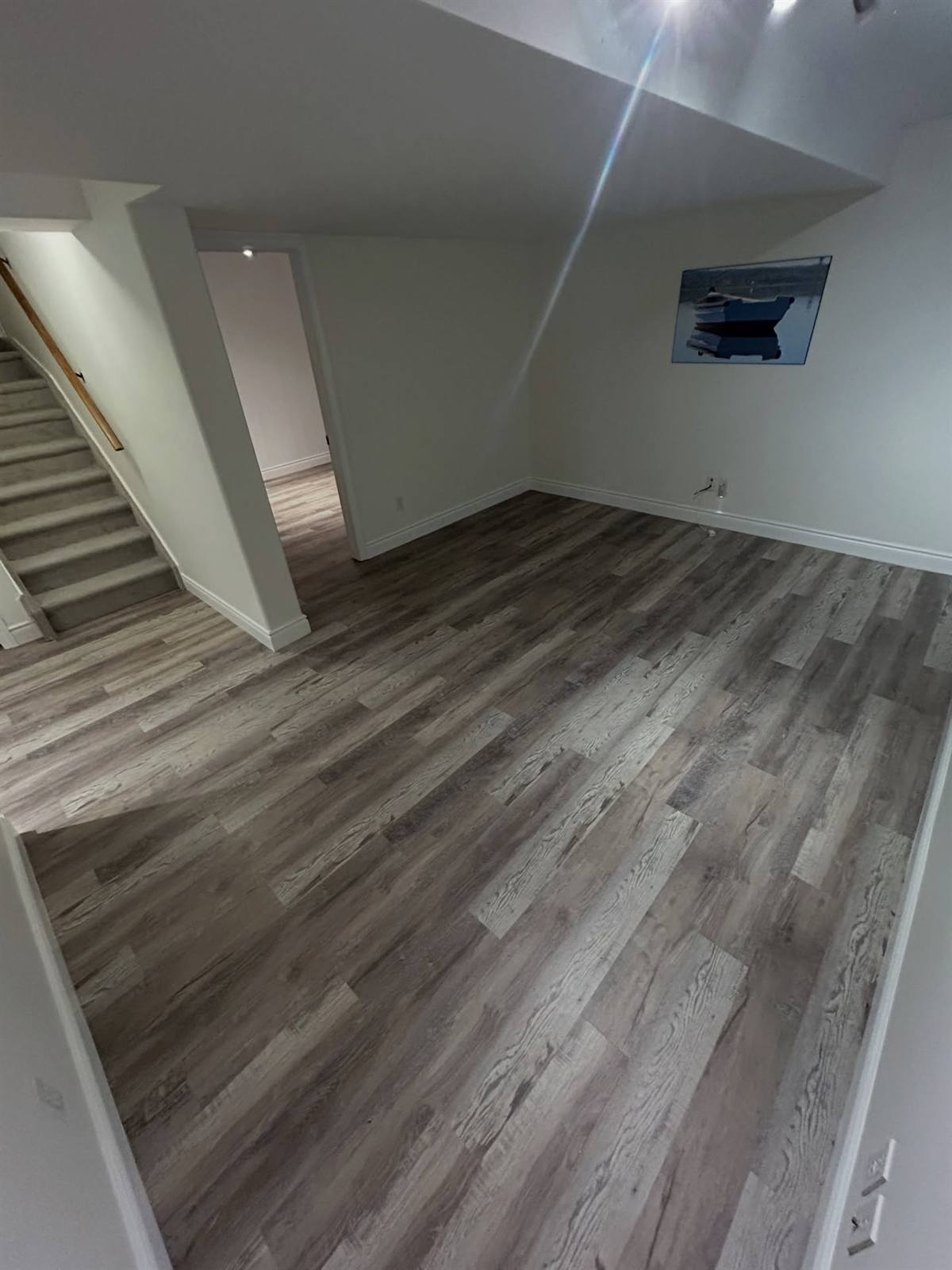 Finished basement with vinyl plank flooring in Kingston, Ontario