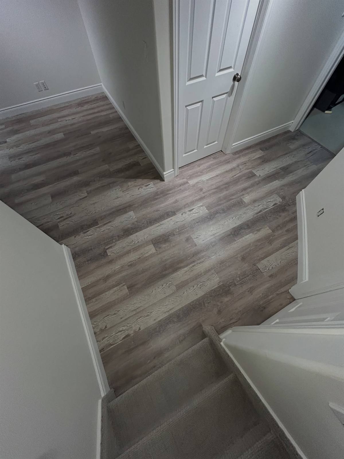 Vinyl plank flooring and stairs in a Kingston basement
