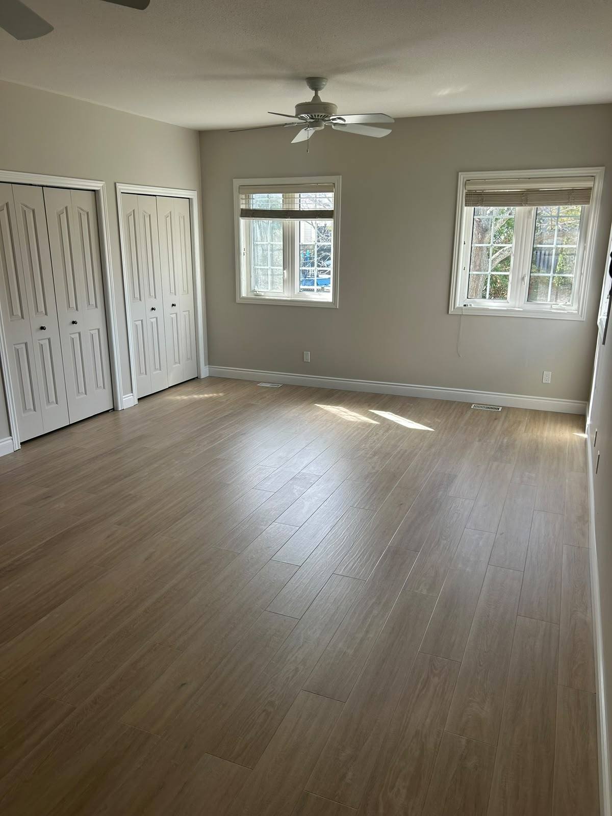 New luxury vinyl plank flooring in a bright bedroom in Kingston, Ontario